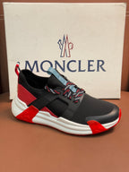 Moncler luxury shoes with black upper, red side stripe, and white cushioned sole