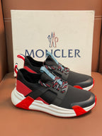 Moncler luxury shoes, black athletic style with red panels and white midsole