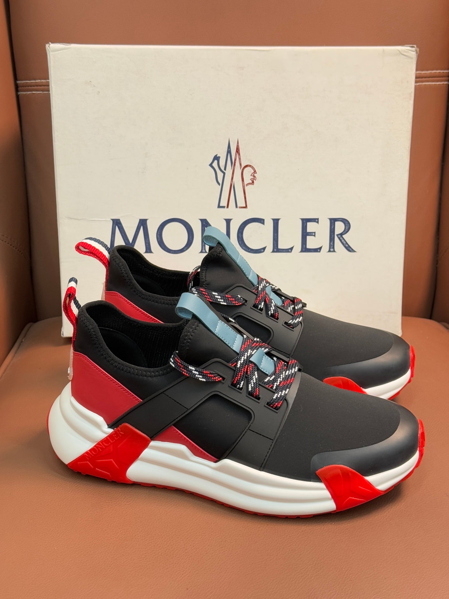 Moncler luxury shoes, black athletic style with red panels and white midsole