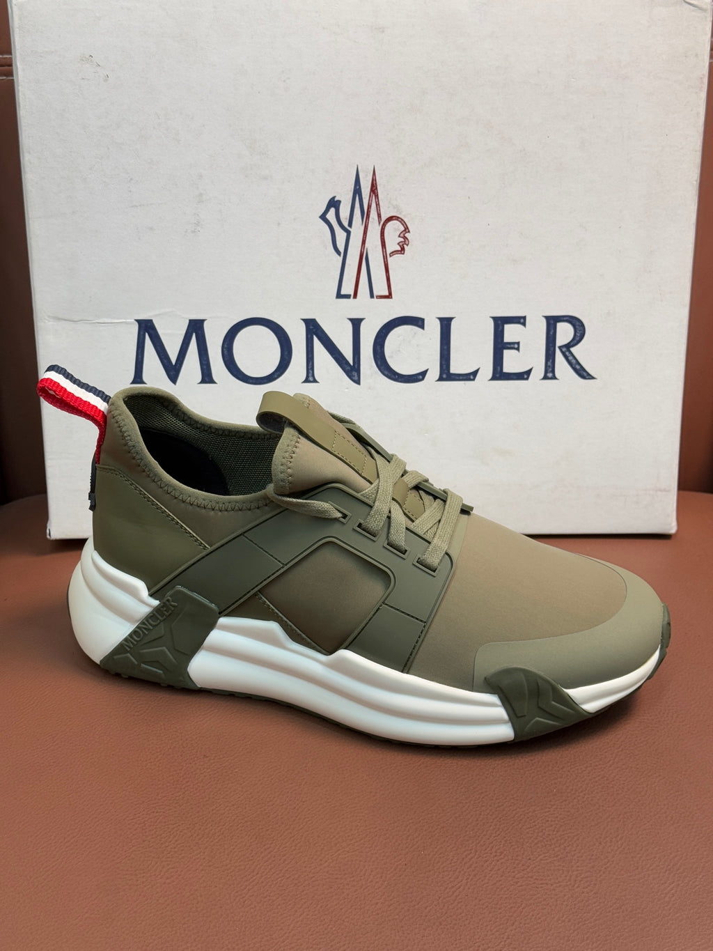 Moncler luxury sneakers in olive green with lace-up and bold white sole
