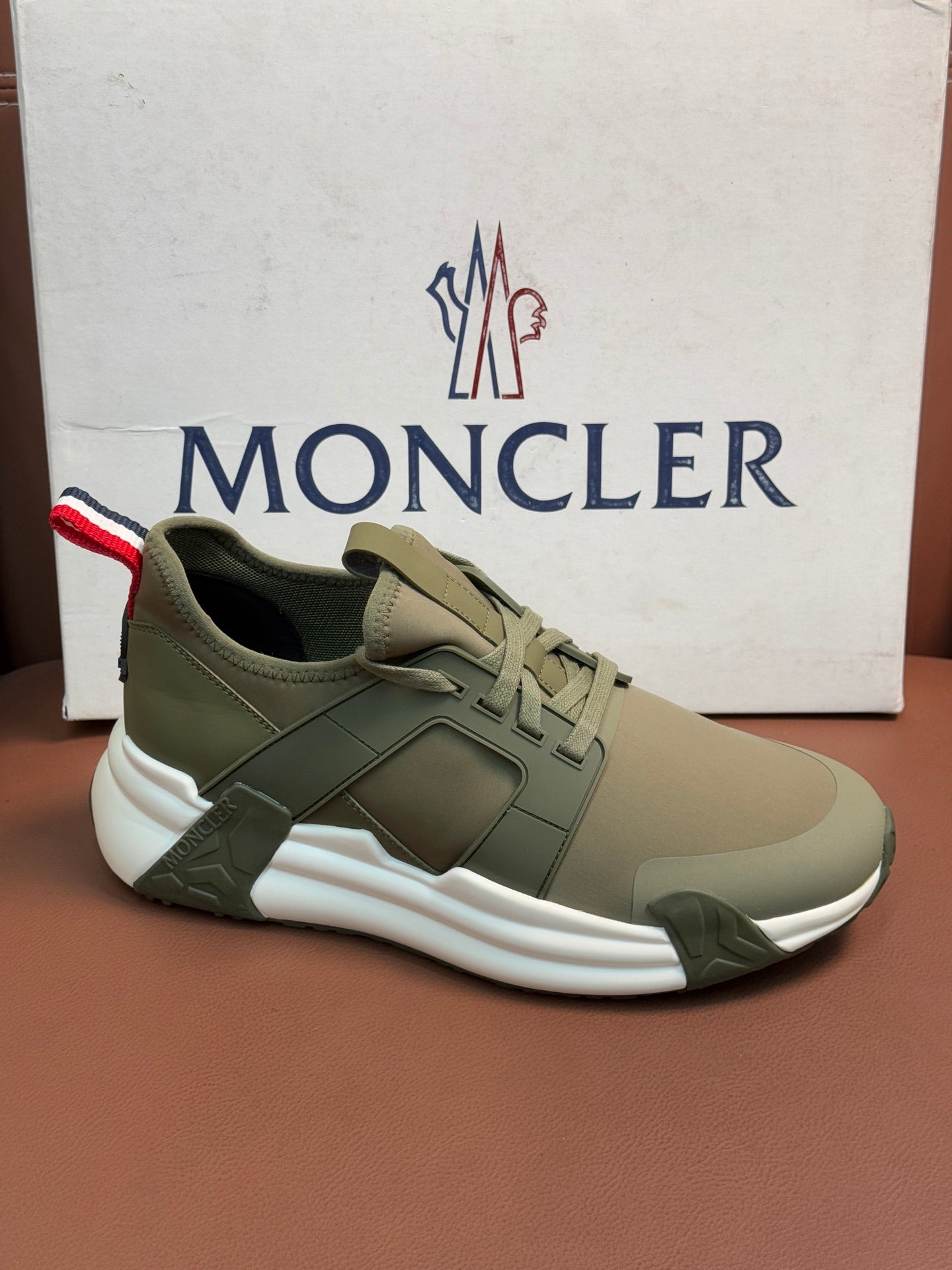 Moncler luxury sneakers in olive green with lace-up and bold white sole