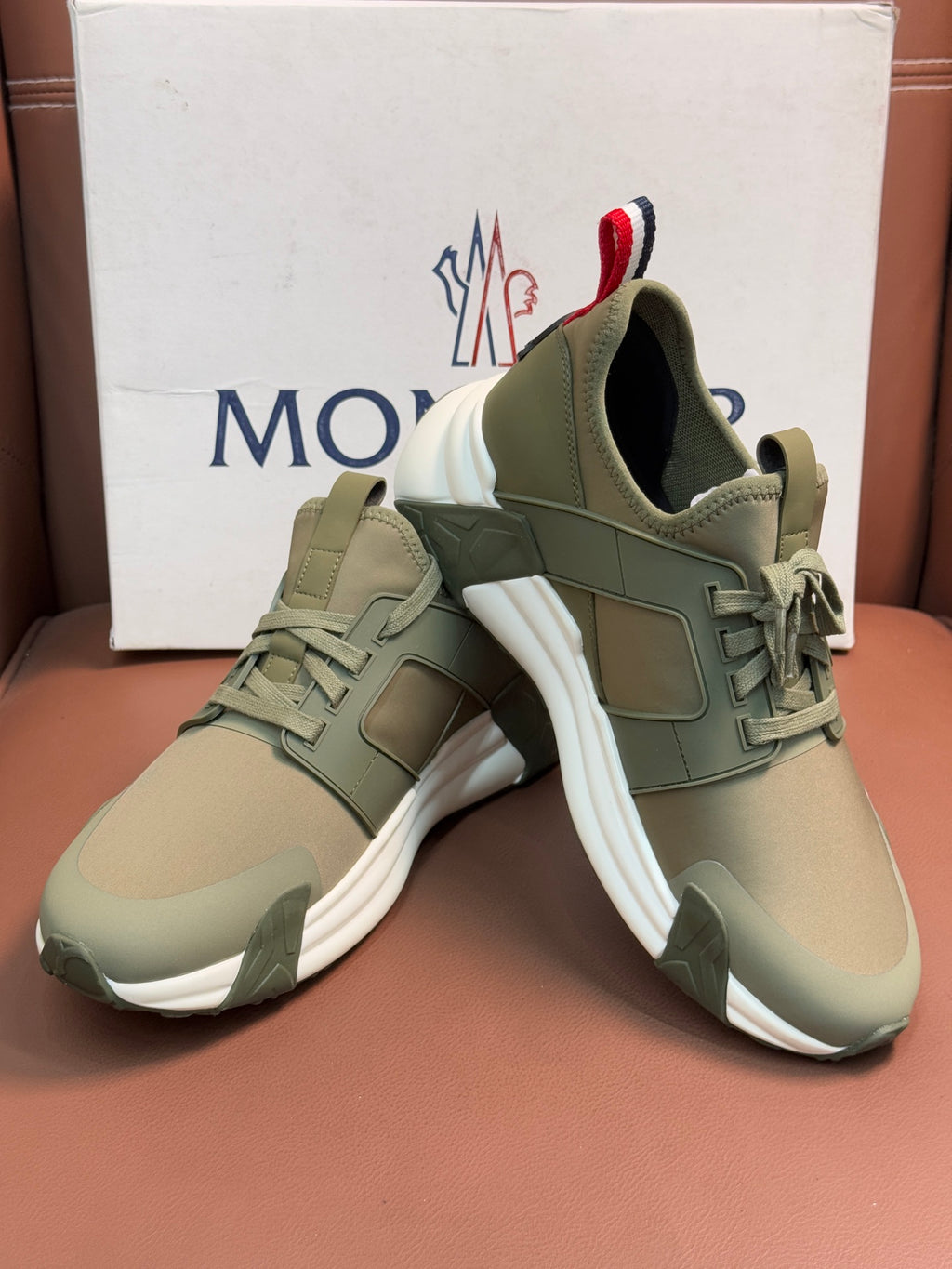 Moncler luxury sneakers in olive green with layered straps and lace-up front