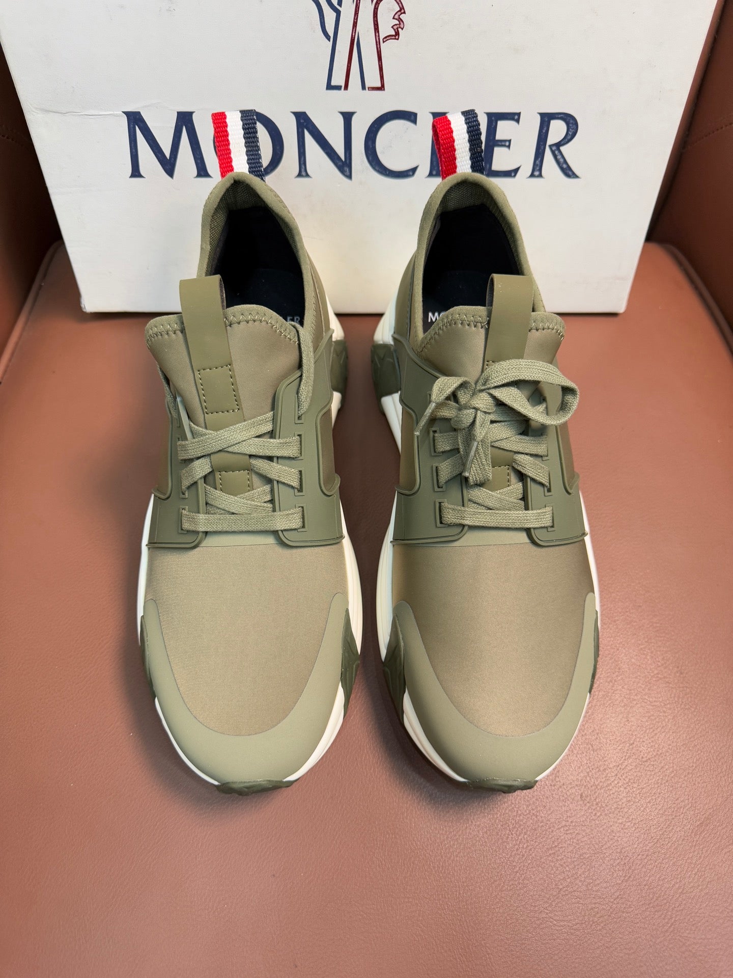 Moncler luxury sneakers in olive green with lace-up front and padded collar