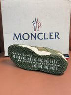 Moncler luxury sneaker outsole with textured olive tread and off-white edge