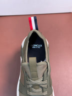 Moncler luxury sneakers, olive green with lace-up, striped pull tab, and logo patch