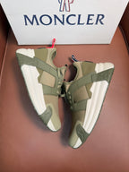 Moncler luxury sneakers with olive green panels, lace-up closure, and chunky white sole