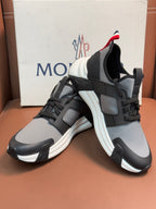 Moncler lace-up sneakers with black-and-gray uppers and red-white heel accents