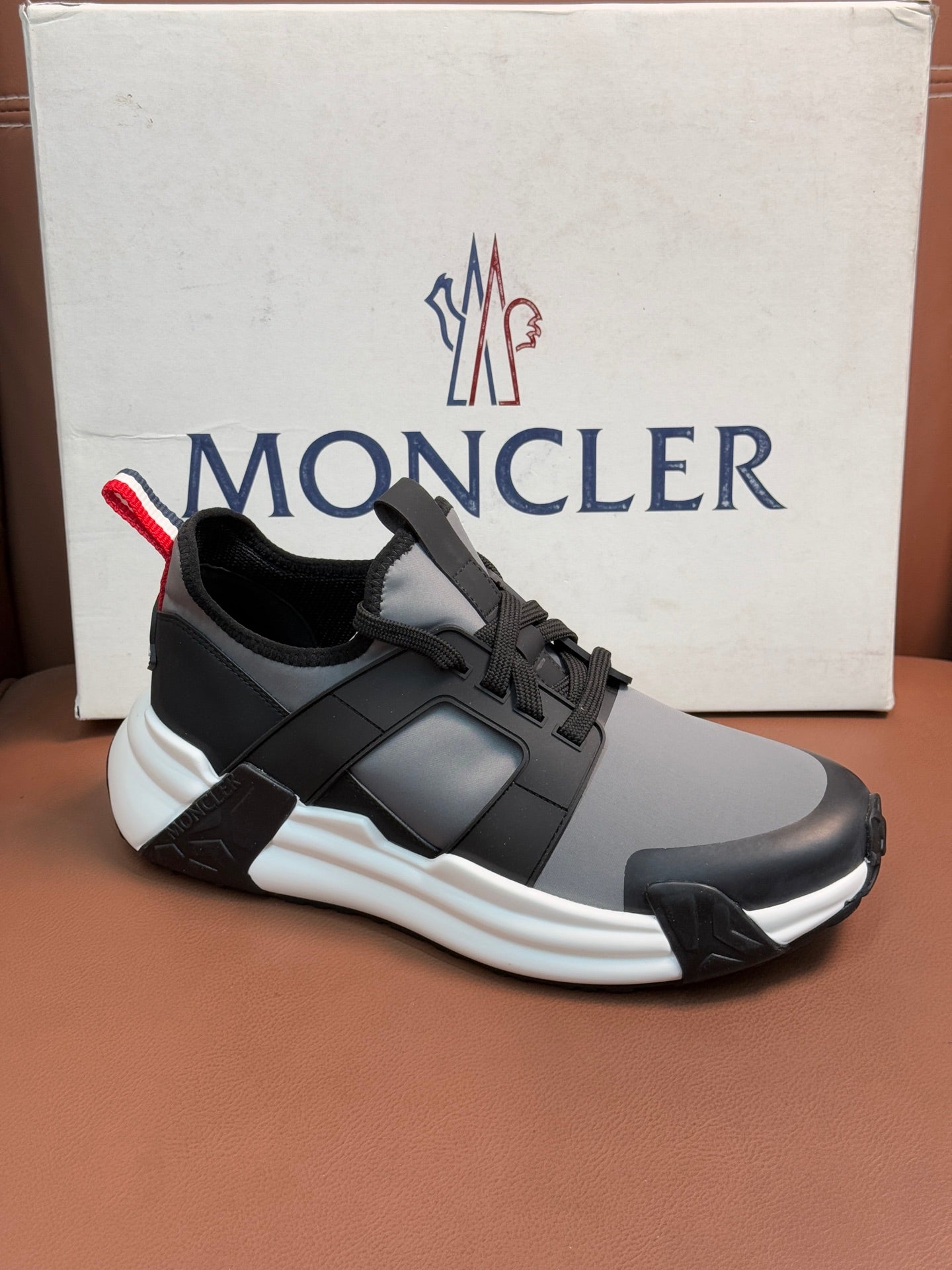 Moncler lace-up sneakers in dark gray with subtle logo and thick white sole