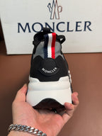 Moncler sneakers heel view with red and blue striped strap and logo tab