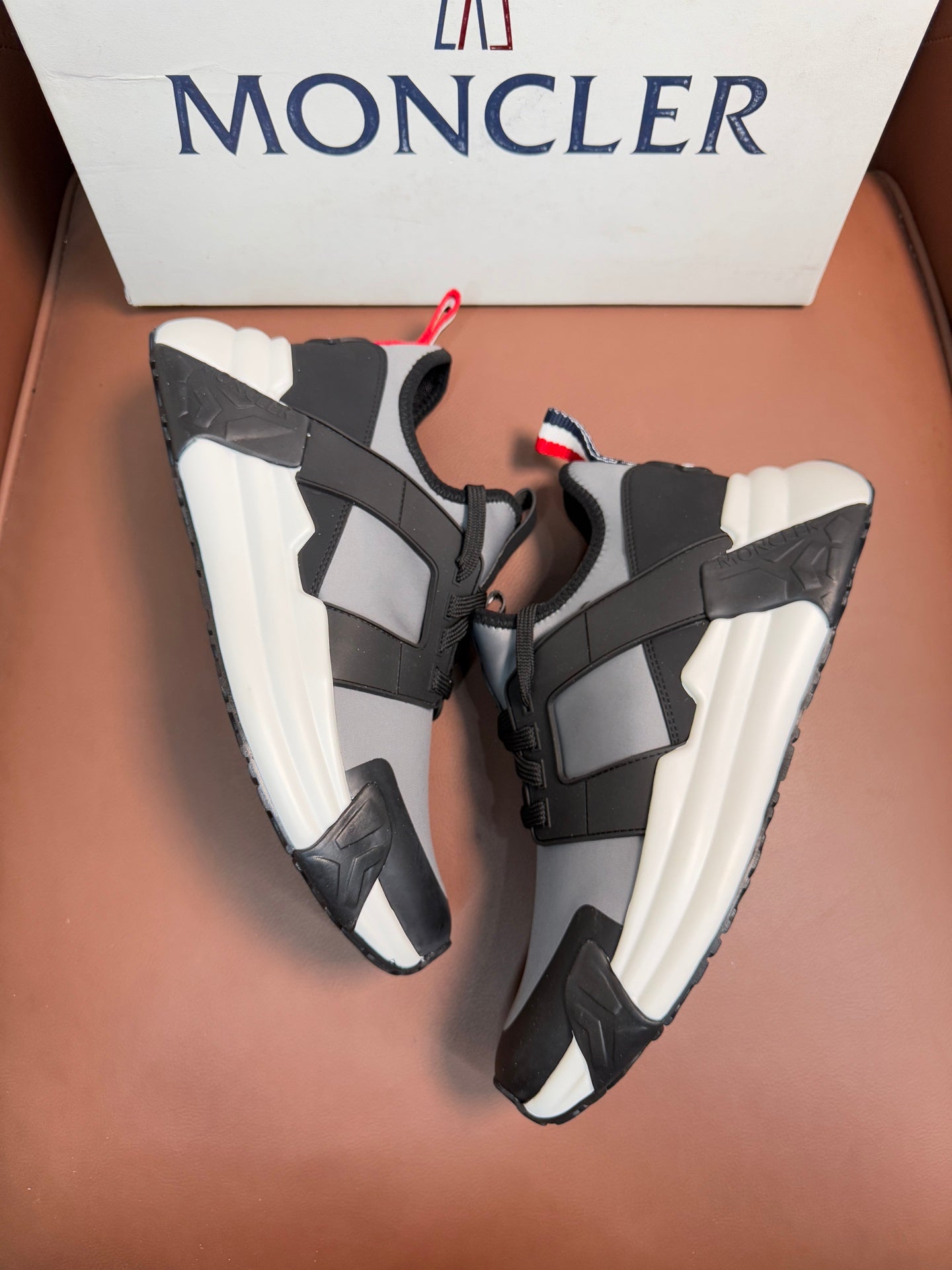 Moncler lace-up sneakers with black and gray panels, thick white midsoles