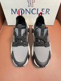 Moncler lace-up sneakers in dark gray with white soles and panel details