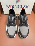 Moncler lace-up sneakers in dark gray with white soles and panel details