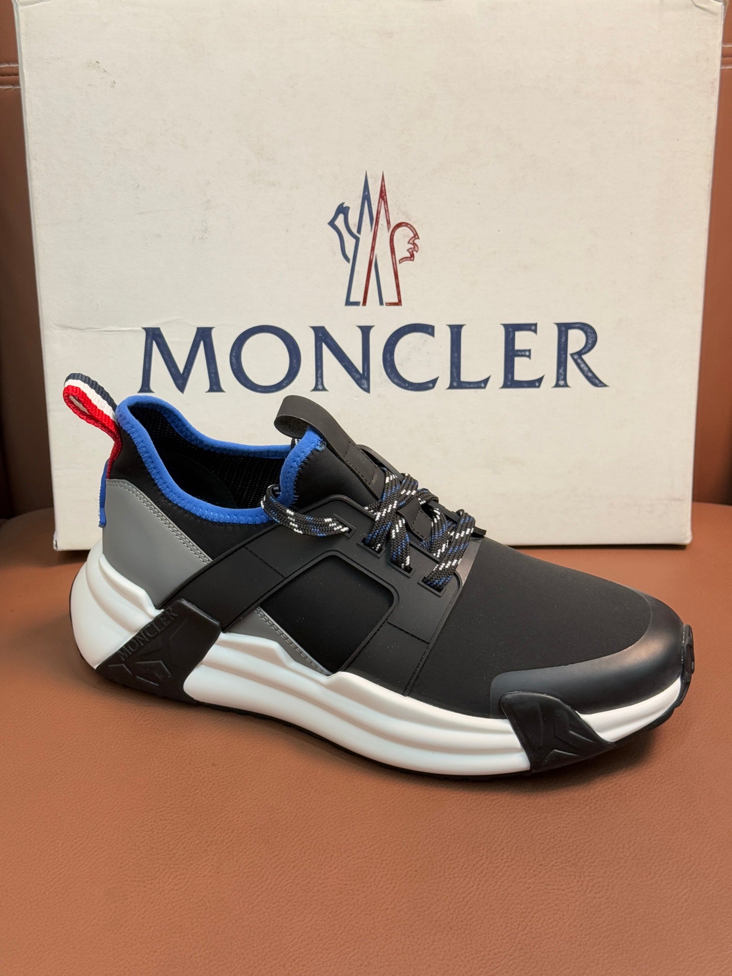 Moncler dark sneakers with blue lining and red/white pull-tab, white sole