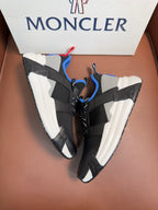 Moncler black sneakers with blue and white panels, red/blue pull-tab, chunky sole