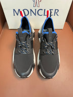 Moncler dark gray sneakers with blue trim and chunky white soles