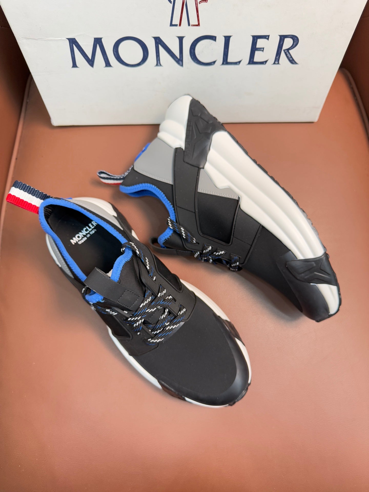 Moncler black sneakers with blue accents, red-white-blue strap detail, white midsoles