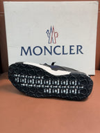 Luxury sneakers outsole view with dark rubber tread and molded circular grip pattern