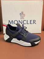 Luxury sneakers with dark navy knit upper, lace-up front, contrast straps and white sole