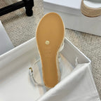Sandal outsole view with size marking and tan bottom on braided jute wedge