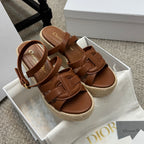 Ladies tan espadrille wedge sandals with crossover straps and gold buckle detail
