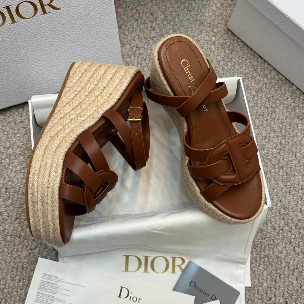 Two-tone tan espadrille wedge sandals with buckled straps and raffia-style platform