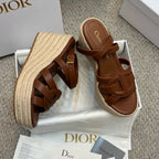 Two-tone tan espadrille wedge sandals with buckled straps and raffia-style platform