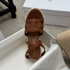 Tan espadrille wedge sandal with wide front buckle strap and ankle strap