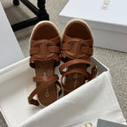 Brown espadrille wedge sandals with ankle buckle straps and cushioned footbed