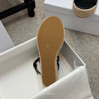 Platform espadrille sandal outsole with tan rubber tread and logo stamp