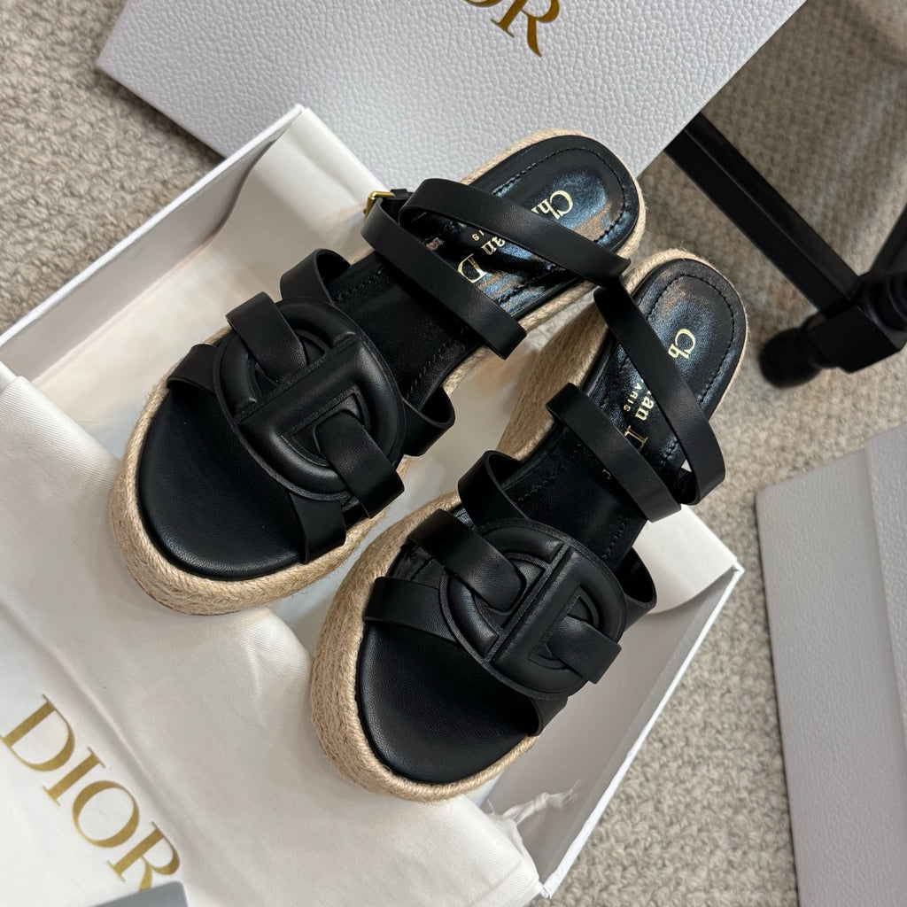 Black platform espadrille sandals with thick straps and embossed buckle details