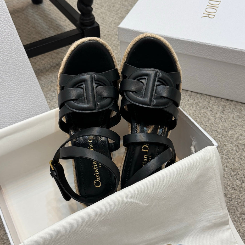 Black platform espadrille sandals with layered ankle straps and braided wedge