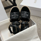 Black platform espadrille sandals with layered ankle straps and braided wedge
