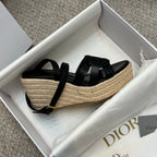 Black platform espadrille sandals with crossover straps and braided jute platform
