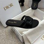 Dior black slide sandal with wide strap and gold Christian Dior logo on footbed