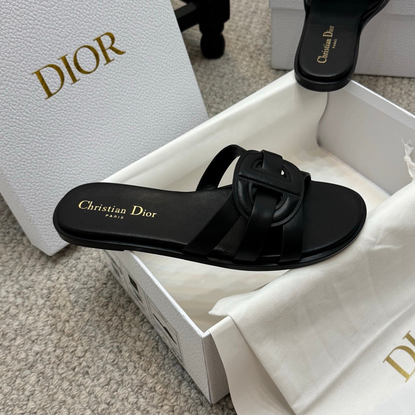 Dior black slide sandal with wide strap and gold Christian Dior logo on footbed