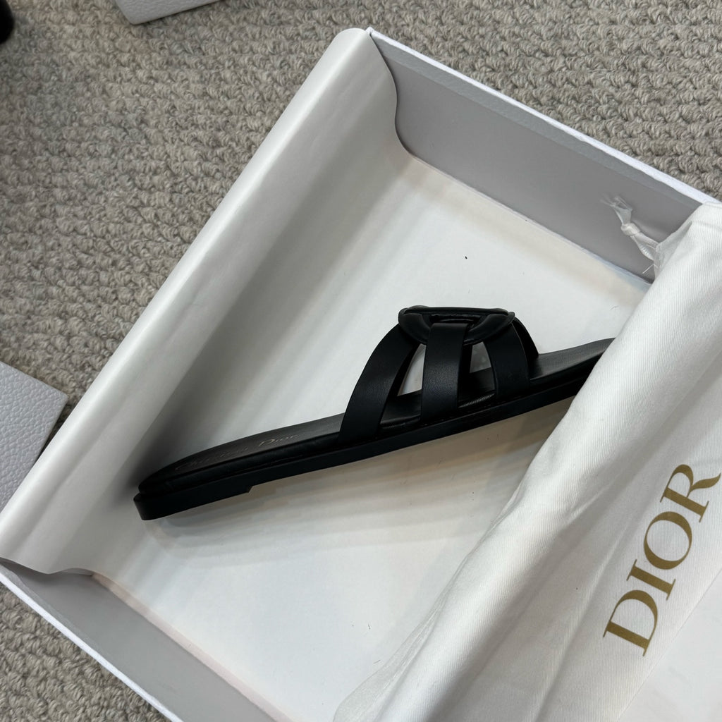 Dior black slide sandal with wide strap and gold logo on footbed