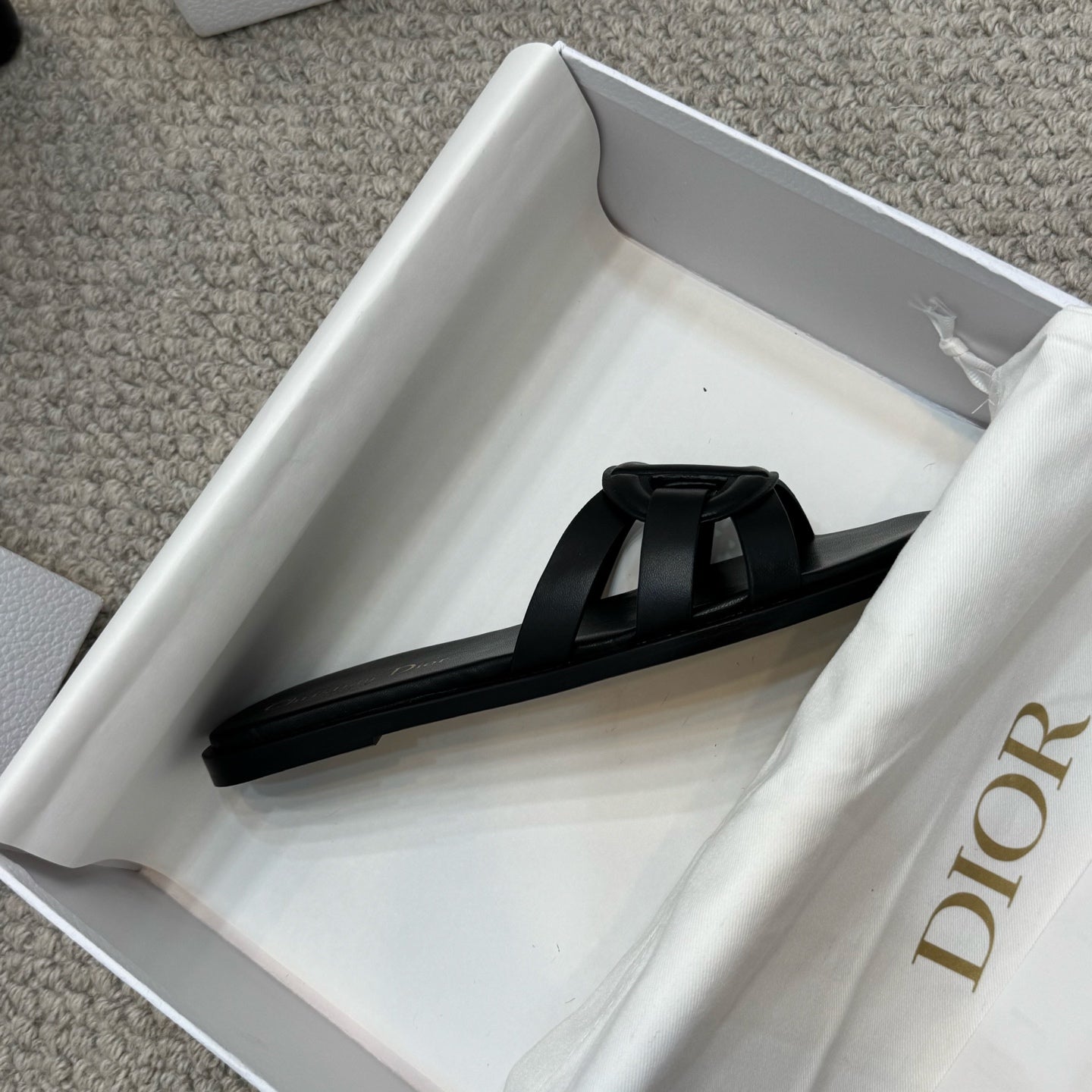 Dior black slide sandal with wide strap and gold logo on footbed