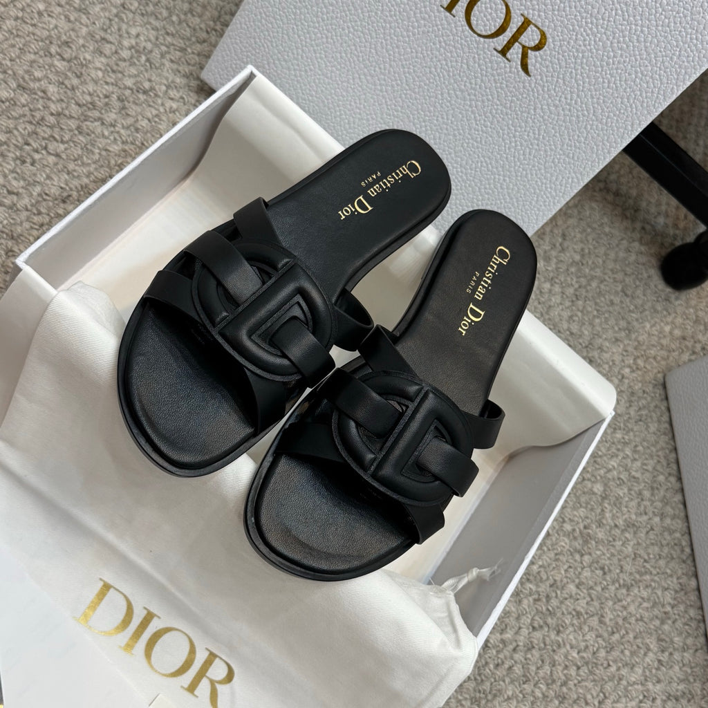 Dior black slide sandals with wide cutout-style straps and gold logo text