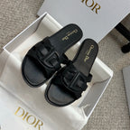 Dior black slide sandals with wide cutout-style straps and gold logo text