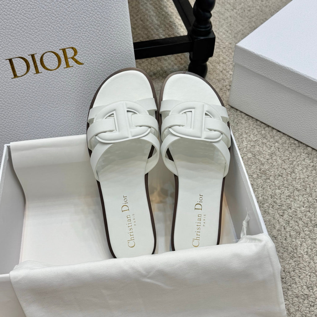 White Dior slide sandals with double front straps and dark-trim outsoles