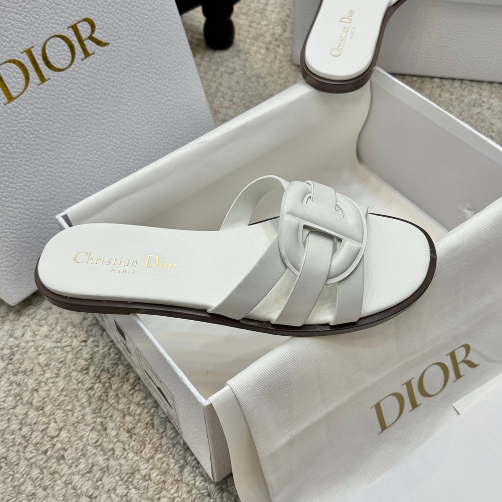 White Dior slide sandal with wide strap and curved dark-trim sole