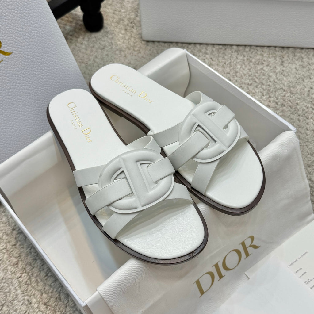 White Dior slide sandals with wide cross strap and dark edge sole