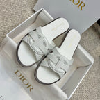 Pair of white Dior slide sandals with knotted-style front strap detail
