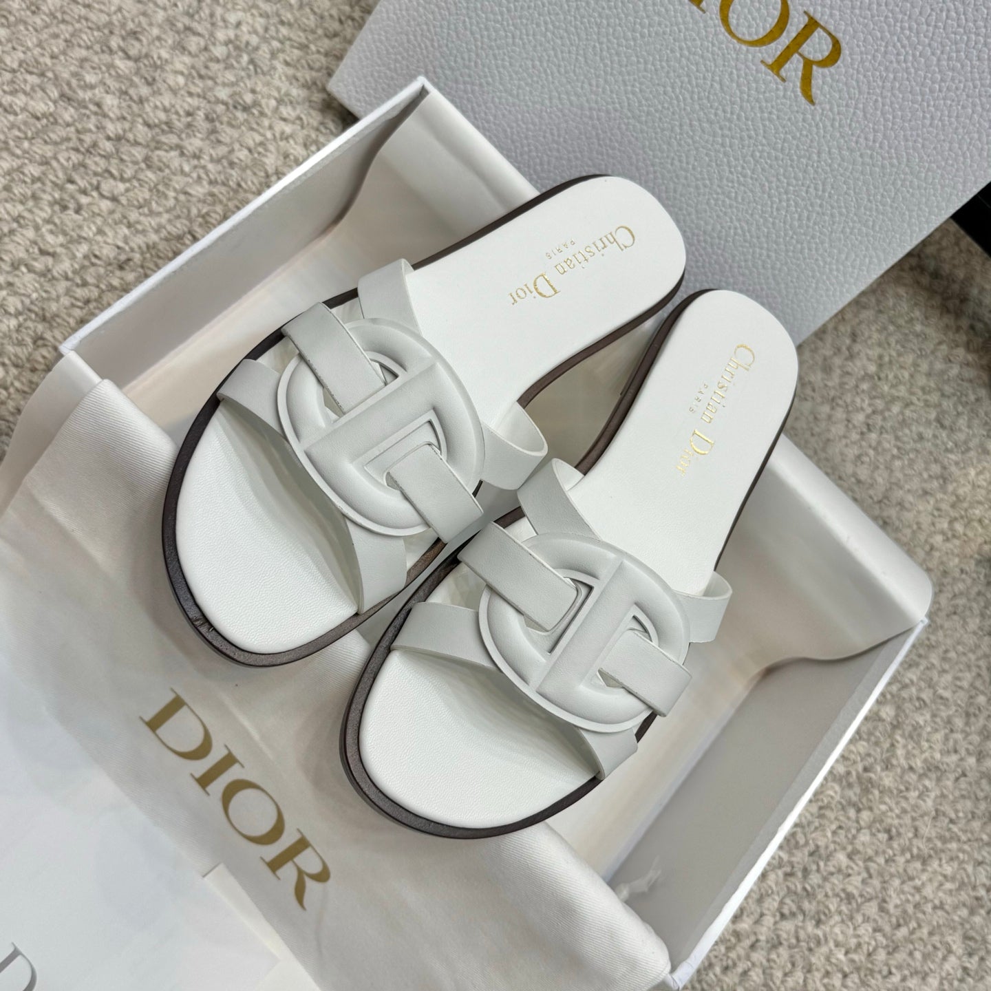 Pair of white Dior slide sandals with knotted-style front strap detail