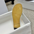 White Dior slide sandal outsole with light gold bottom and grip pattern