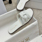 White Dior slide sandal with strap detail on footbed