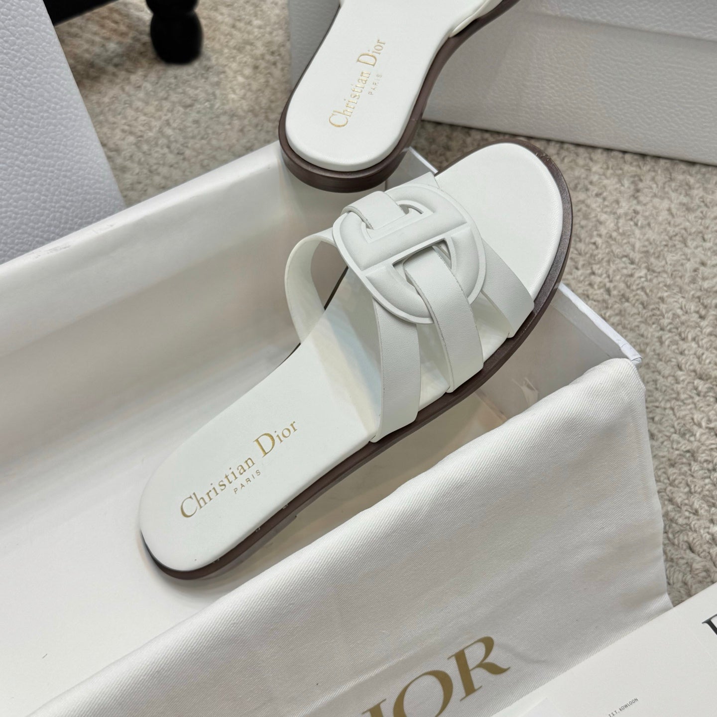White Dior slide sandal with strap detail on footbed
