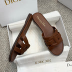 Brown leather Dior slide sandals, close-up of side straps and footbed