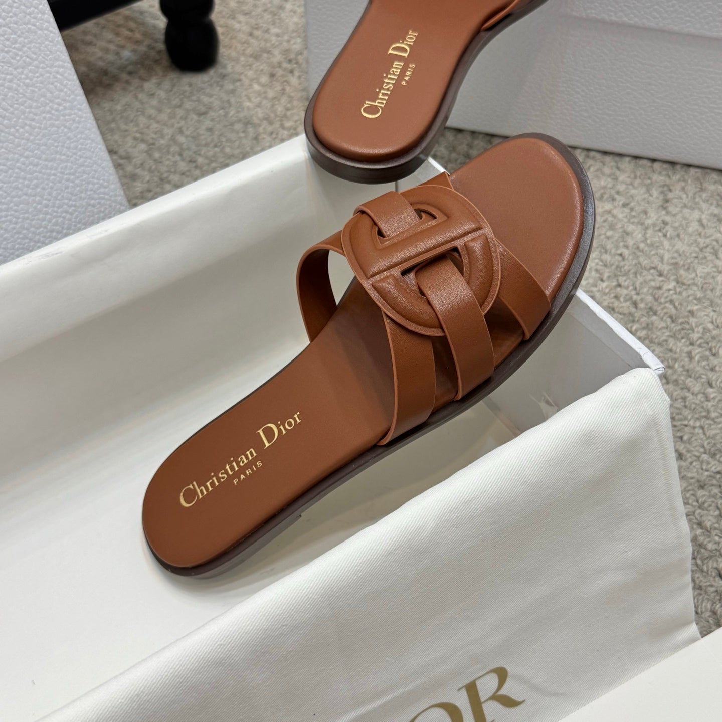 Brown leather Dior slide sandal, close-up of footbed and knotted strap detail