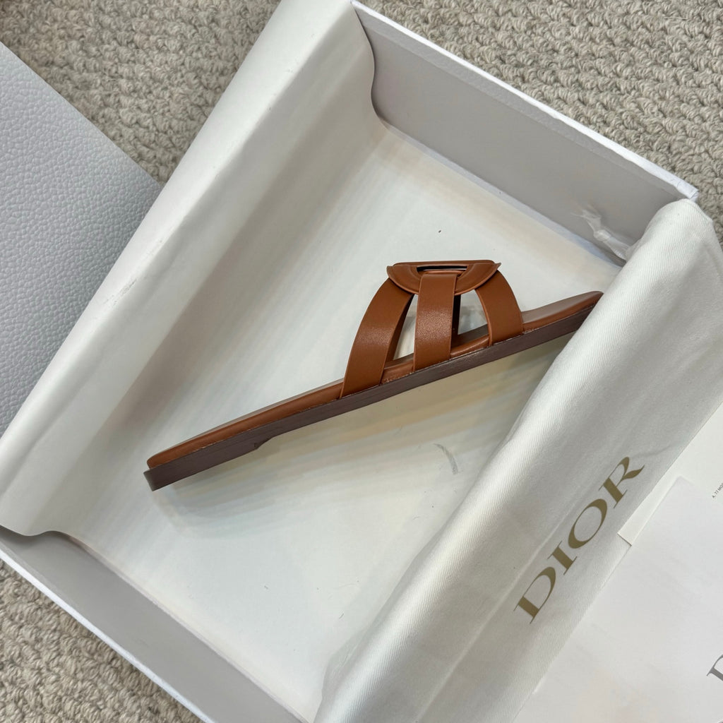 Brown leather Dior slide sandal, side view with curved outsole